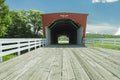 Low angle of Hogback Covered Bridge with road planks and blue skies