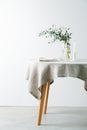 Low angle image of a served round table with a white tablecloth