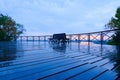 Low-angle landscape view of wooden platform with empty wooden benches in the park. Rainy autumn morning in Artist`s alley Royalty Free Stock Photo