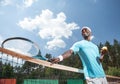 Jolly man is enjoying tennis match in open air