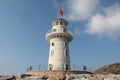 Low angle a lighthouse of Alanya port with the Turkish flag