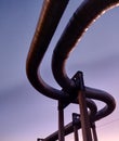 Low angle of live steam pipeline fixed above the ground with huge stone constructions