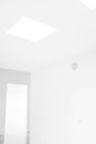 Low angle look of a modern designed room with white lights and white walls Royalty Free Stock Photo