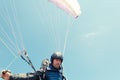 Low angle of male paraglider holding ropes Royalty Free Stock Photo