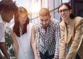 Discussing new project. Group of modern people having a meeting while standing in the creative office Royalty Free Stock Photo