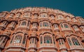 Low-angle of a mesmerizing exterior of The Hawa Mahal palace in Jaipur, India, with a blue sky above