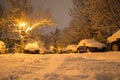 Low angle of a narrow street with parked cars, covered with snow, after a snow blizzard in Bucharest, Romania