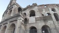 Low angle pan right on Colosseum in Rome largest amphitheater in the world also known as Amphitheatrum Flavium