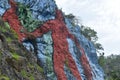 Low-angle partial view of the colorful Mural de la Prehistoria wall