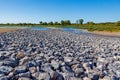 Low angle perspective of gravel and stones on floodplain in Maas river