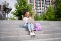 Low angle photo of beautiful funny girl sitting stairs student celebrate passed her final online test in laptop raised Royalty Free Stock Photo