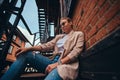 Low angle photo of cheeky woman in sunglasses and denim at back yard. Royalty Free Stock Photo