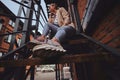 Low angle photo of cheeky woman in sunglasses and denim at back yard. Royalty Free Stock Photo