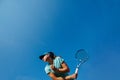 Low angle photo of girl playing tennis, holding racket backhand Royalty Free Stock Photo