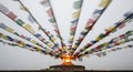 Colorful prayer flags blur above a sacred flame Royalty Free Stock Photo