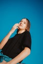 Low angle portrait of beautiful teenager girl at blue sky background. Royalty Free Stock Photo