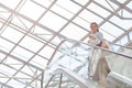 Young Woman on Escalator in Mall Royalty Free Stock Photo