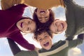 Low Angle Portrait Of Children Having Fun Playing Outdoors Linking Arms Looking Down Into Camera