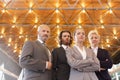 Low angle portrait of confident business team standing against illuminated roof