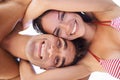 Low angle, portrait and couple hug with smile, bonding at beach for travel and love in relationship for commitment. Man Royalty Free Stock Photo