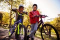 Low angle portrait siblings with bicycles in park