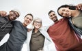 Low angle portrait of team of business people hugging each other. Diverse group of men and women standing in a together Royalty Free Stock Photo