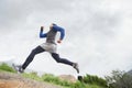 Low angle, runner and man running in nature training, cardio exercise and endurance workout for wellness. Sports Royalty Free Stock Photo