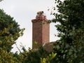 Low angle selective focus shot of a chimney made of bricks