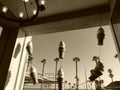 Low-angle sepia of ice creams hanging from the shop open window, sky background
