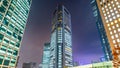 Low angle of the Shiodome Media Tower at night against a purple night sky Royalty Free Stock Photo