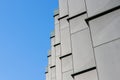 Low angle shot of an abstract building facade on blue sky background Royalty Free Stock Photo