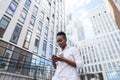 African american woman with backpack walking outdoor and talking on mobile phone Royalty Free Stock Photo