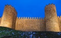 Low angle shot of ancient Avila city walls under a blue sky Royalty Free Stock Photo