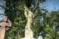 Low angle shot of an angel memorial statue on a grave in Nunhead cemetery London in England