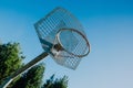 Low angle shot of a basketball hoop under a clear blue sky Royalty Free Stock Photo