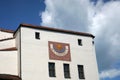 Low angle shot of a beautiful facade with a sundial of an old building Royalty Free Stock Photo