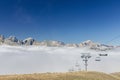 Low angle shot of a beautiful view of the mountains with a chairlift line going through the clouds Royalty Free Stock Photo