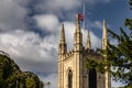 Low-angle shot of the Blackburn Cathedral with the United Kingdom flag on top on a sunny day