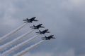 Low angle shot of the Blue Angels performing an air show before the clouds Royalty Free Stock Photo