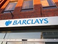 Low angle shot of the blue logo of Barclays in front of the Bank in Rugby