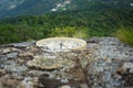 A low-angle shot captures a modern wall clock resting horizontally on a rough Royalty Free Stock Photo