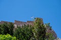 Low angle shot of the Castle of Monolithos with a Greece flag