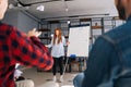 Low-angle shot of cheerful young business lady finishing presentation on whiteboard. Royalty Free Stock Photo