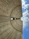 Low angle shot of a contemporary concrete wall under a blue cloudy sky