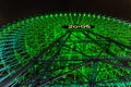 Low angle shot of the Cosmo Clock 21 Ferris Wheel at night and illuminated with green lights Royalty Free Stock Photo