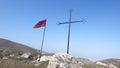 Low angle shot of a cross and the Armenian flag on a hill Royalty Free Stock Photo