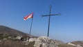 Low angle shot of a cross and the Armenian flag on a hill Royalty Free Stock Photo