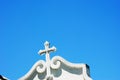 Low angle shot of a cross at the top of a white building on a blue background Royalty Free Stock Photo