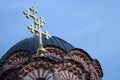 Low-angle shot of crosses on the dop of a dome on the blue sky background