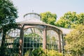 Low angle shot of a dome building with window walls surrounded by green trees Royalty Free Stock Photo